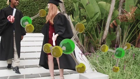 Two grads walking down steps with diplomas, cheering while 3D molecule partly Stock Footage 333278208