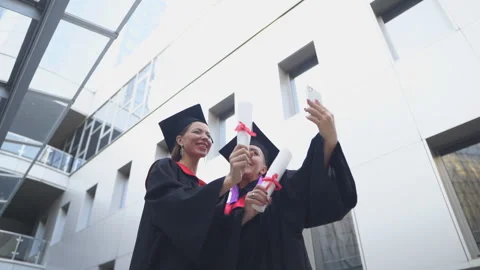 Two graduates take a selfie. Capturing happy moments. Stock Footage 141618108