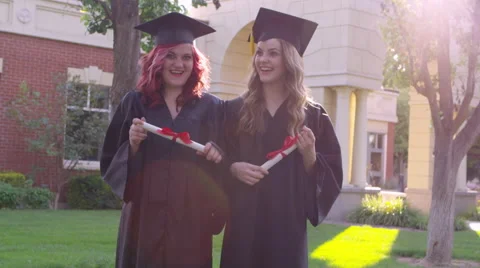 Two graduating students with diplomas Stock Footage 67298596