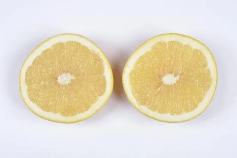 Two grapefruit halves on white background Stock Photos