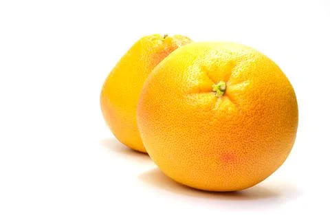 Two grapefruits on a white background are located one after the other Stock Photos