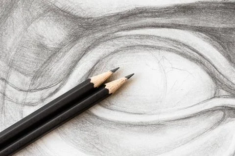 Two graphite pencils on drawing of David s eye two wooden graphite pencils... Stock Photos