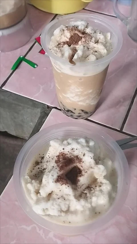 Two grass jelly ice chips that have been topped with chocolate powder Stock Footage 294892400