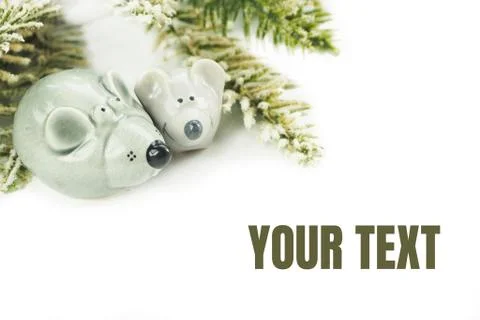 Two gray ceramic mice with artificial spruce branches with snow. Isolate on a Stock Photos