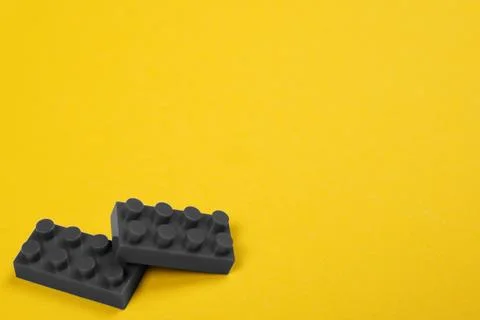 Two gray constructor elements on yellow. Stock Photos