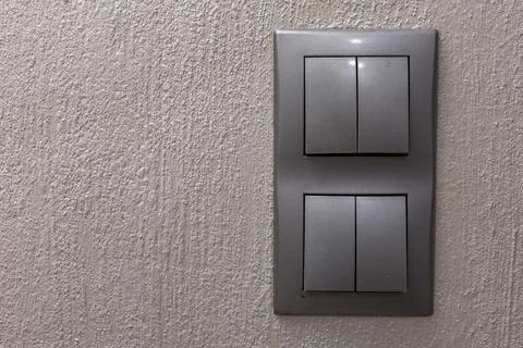Two gray double light switches mounted on the wall Stock Photos