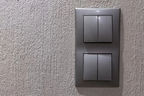 Two gray double light switches mounted on the wall Stock Photos