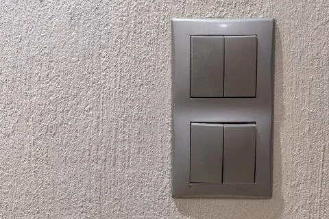 Two gray double light switches mounted on the wall Stock Photos