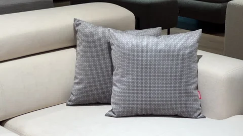 Two Gray Patterned Decorative Pillows on Modern White Leather Sofa. Luxury Hotel Stock Footage 335253832