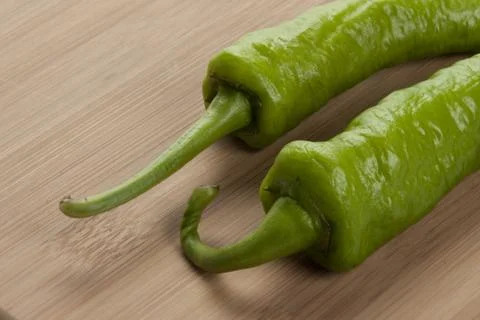Two greem chilis Stock Photos