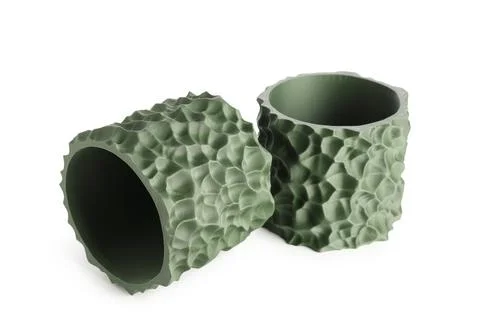 Two green 3D printed textured cylinders with organic pattern, modern manufact Stock Photos