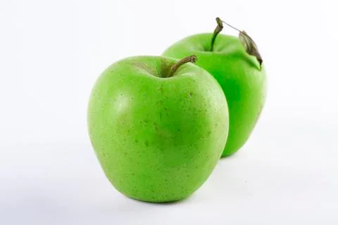 Two green apples on a white background. Stock Photos