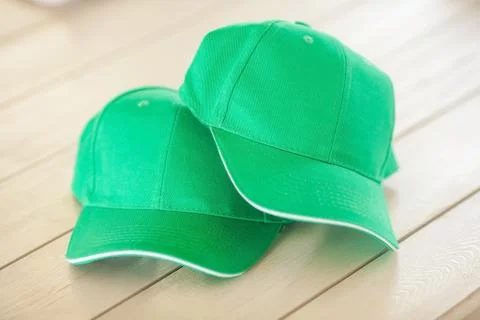 Two green baseball caps Stock Photos