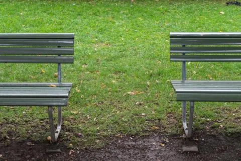 Two green bench separated from each other Stock Photos
