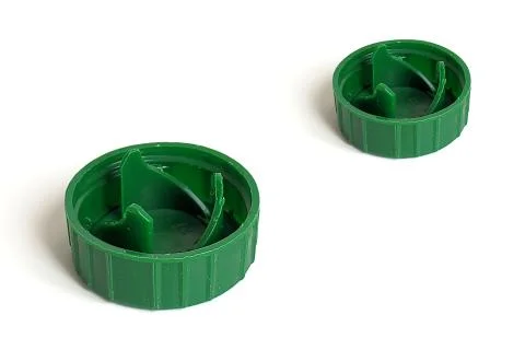 Two green caps from soft drink bottle isolated on white background Stock Photos