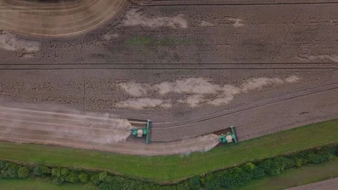 Two green combine harvesters move in parallel across wheat field Video stock 324795877