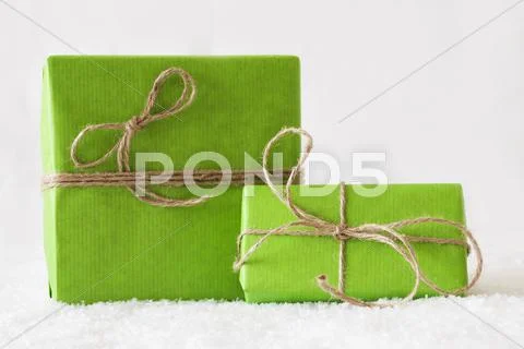 Two Green Gifts Or Presents On Snow, White Background Stock Photos