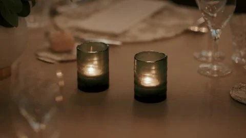 Two Green Glass Candle Holders Glowing on Wedding Dinner Table Stock Footage 344013426