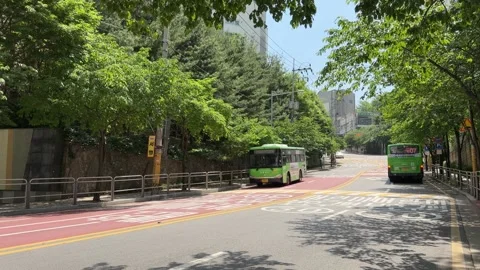 Two Green Local Buses Passing Each Other on Quiet Seoul Residential Street Vídeo Stock 342194932