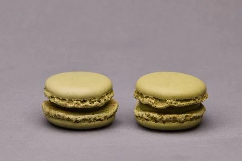 Two green macarons on gray background Stock Photos