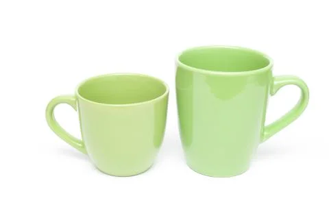 Two green mugs empty blank, isolated on white background Fotos Stock