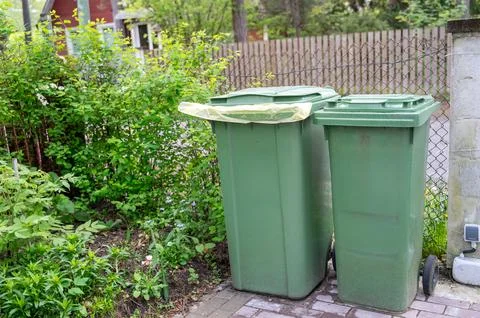 Two green plastic garbage bins Stock Photos