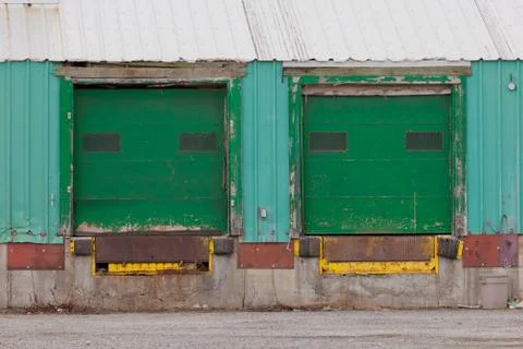 Two green shuttered outside loading gate ramps Stock Photos