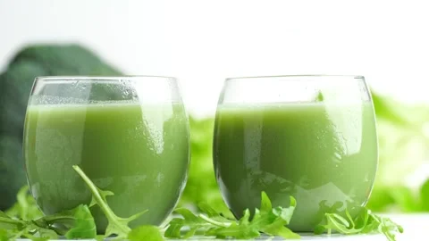 Two green smoothie on the green vegetables background, rotating, slow motio.. Stock Footage 263189699