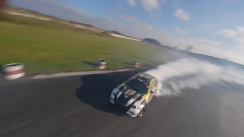 Two Green-Yellow BMWs Drift Smoothly with FPV Aerial Shots 스톡 동영상 325449529