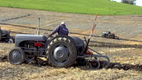 Two grey tractors competing in parallel in a ploughing match in Wiltshire, UK 스톡 동영상 331288607