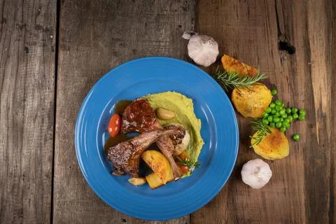 Two grilled lamb chops served on pea puree with a mint sauce Stock Photos