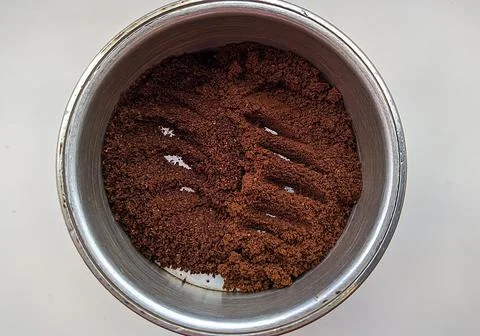 Two ground coffee varieties in one coffee pot on a white background top view. Fotos Stock