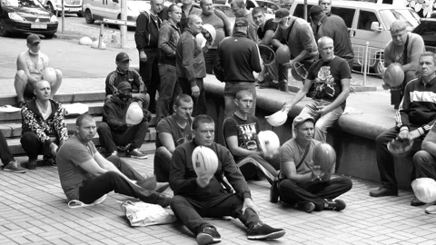 Two groups of miners on manifestation, sit-in strike with helmets. Stock Footage 134632475