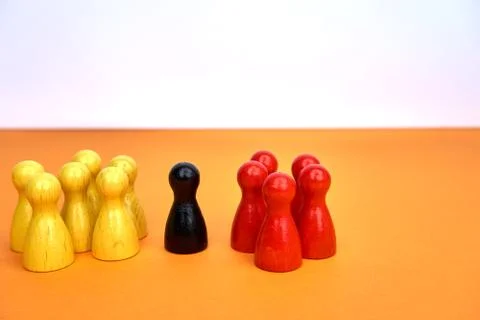 Two groups with on person in the middle - can be used for inclusion, racism or Stock Photos