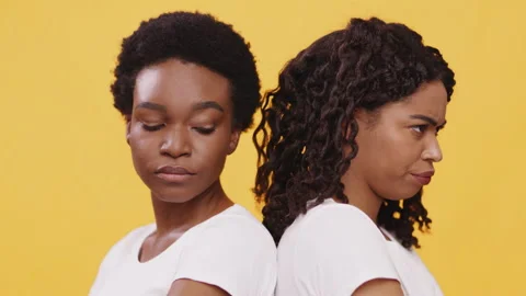 Two grumpy african american female friends standing back to back, feeling Stock Footage 148245504
