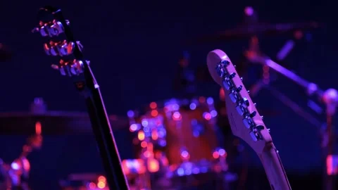 Two guitars and red drums are on an empty stage before a concert Video stock 155377697