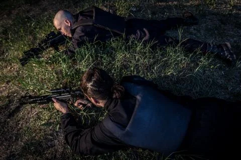 Two gunman in combat in the field Stock Photos