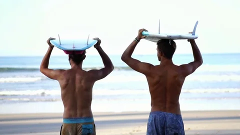 Two guy friends on beach with surfboards. summer holiday travel adventure.  Stock Footage 108564785