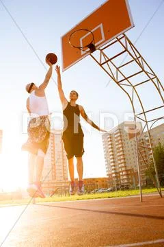 Two Guy Play Basketball At District Sports Ground
