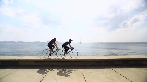 Two Guy Riding Fixie Near by the Sea Video stock 41862369