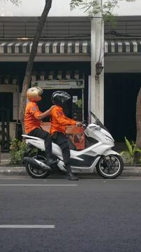 Two guy riding Scooter Stock Photos