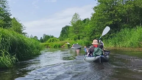Two guys are actively paddling on an inflatable kayak Stock Footage 236557214