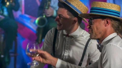 Two guys are lifting their glasses up and smiling Stock Footage 112196426