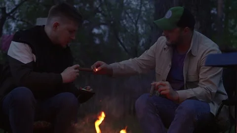 Two guys are lighting cigars. Stock Footage 277110012
