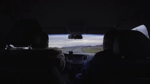 Two guys are sitting in the front seats of the car Stock Footage 130459850