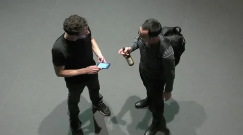 Two guys are talking, one with a bottle of beer 스톡 동영상 61042951