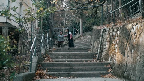 Two guys are training parkour. They jump down the stairs doing a backflip on an Video stock 120241584