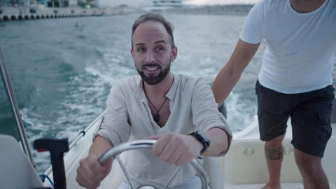 Two guys on a boat laughing at something in Spain Video stock 265906540