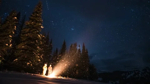 Two guys at a campfire in the winter under the stars Stock Footage 167049031