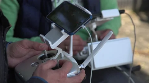 Two guys control the drone from the remote control. fly a drone. Stock-Footage 142825408